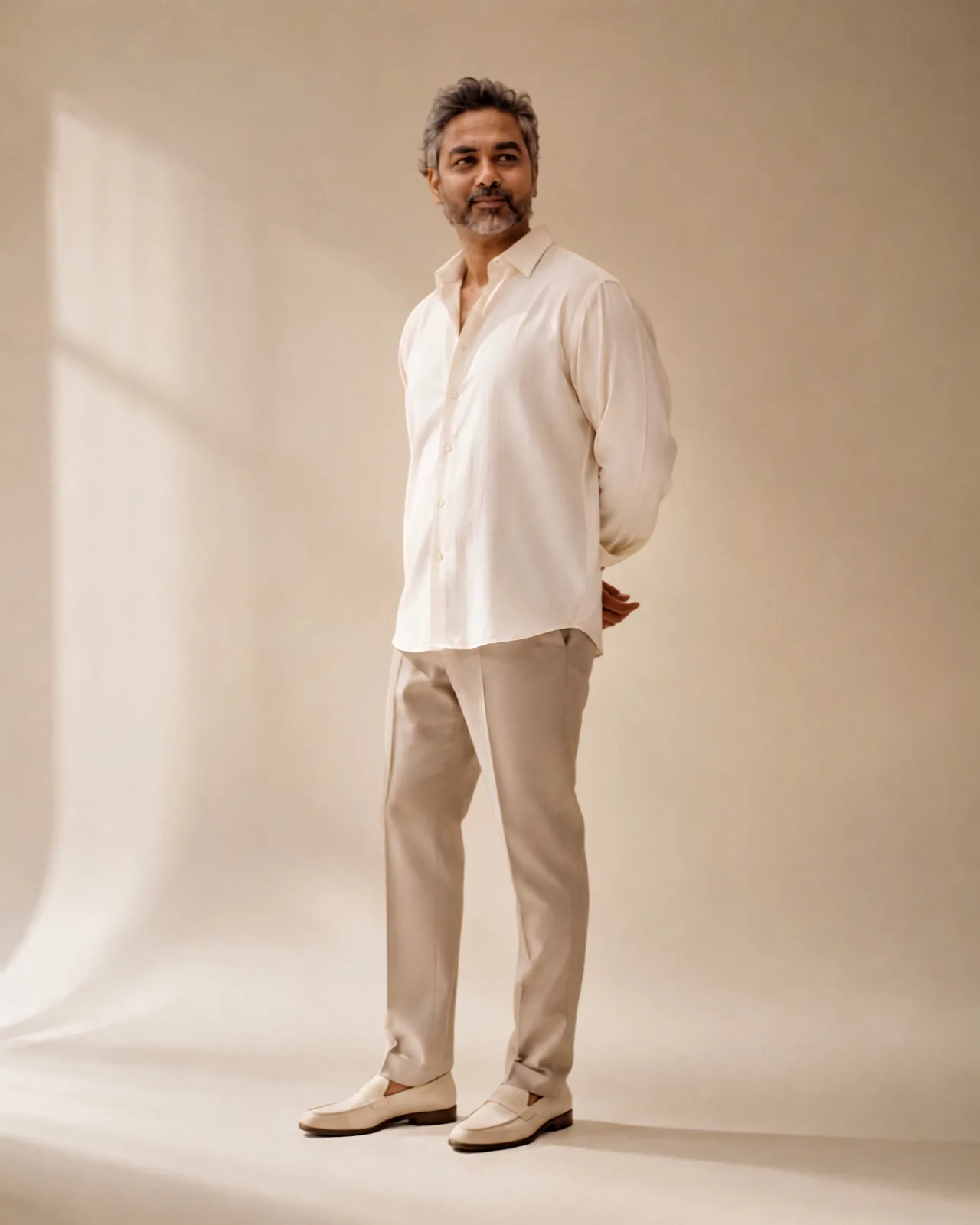 Aabhishek Siloya standing in a warm, neutral studio.
